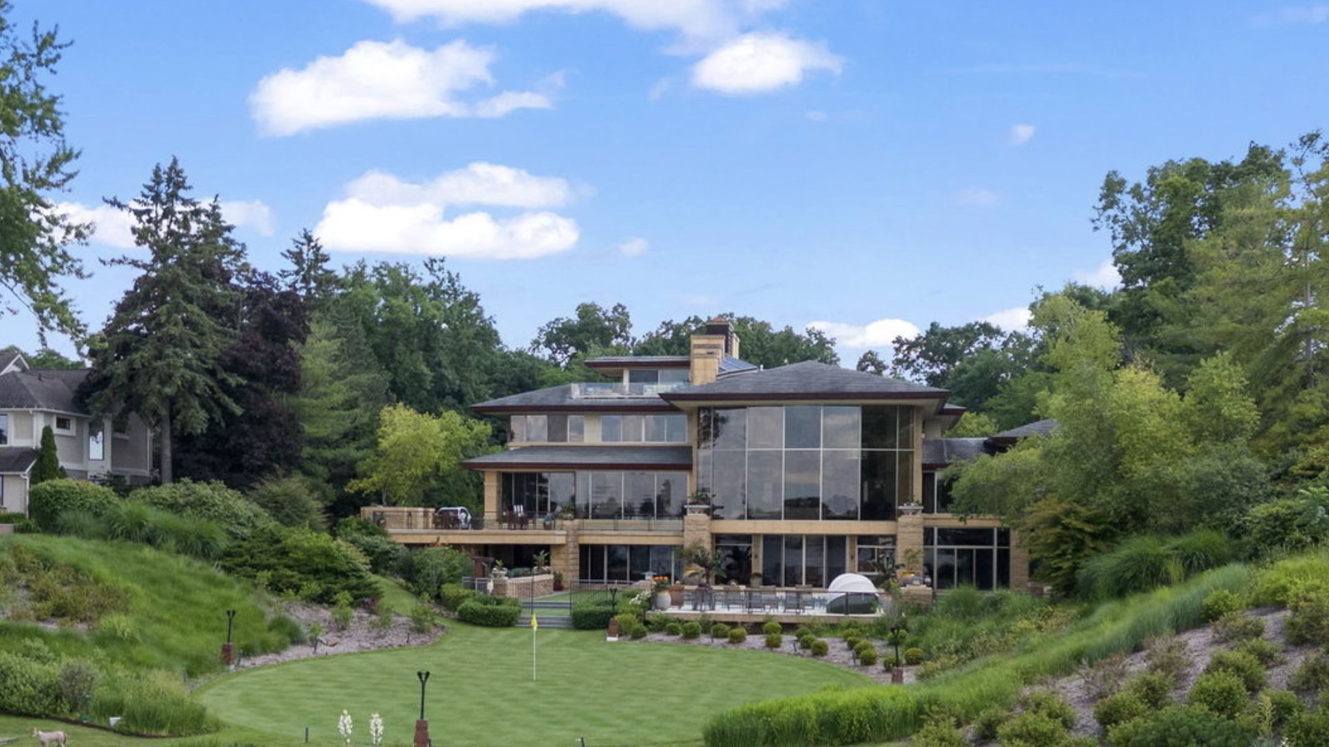 Waterfront lot with lawn, plantings, and stone beach — Oakland County